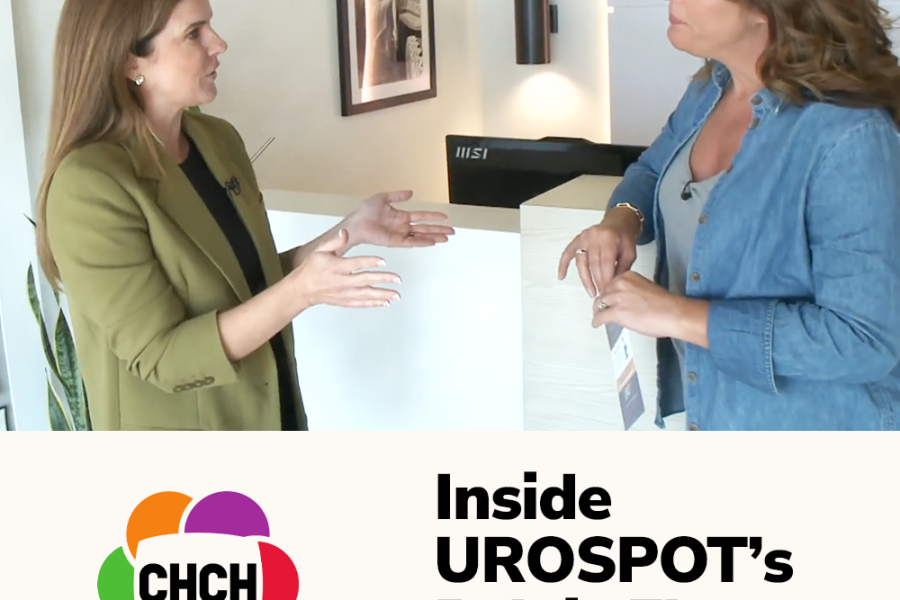 Two women engaged in a conversation about UROSPOT's pelvic floor care in a modern office setting.
