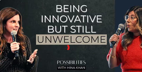 Hina Khan and Erin Craven on stage with microphones, against a dark backdrop featuring bold text, one speaker wearing a red dress and the other in dark attire.